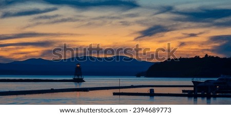 Colorful view at dusk of North Lighthouse and Breakwater in Lake Champlain from Burlington, Vermont.