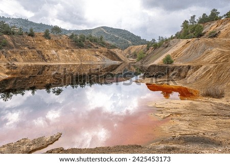 Colorful view of Sia Mine Red Lake, a former copper and pyrite mine excavation basin filled with water,  forming an impressive location, located near Sia Village, Nicosia district, Cyprus