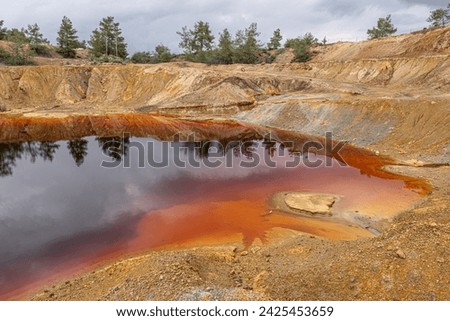 Colorful view of Sia Mine Red Lake, a former copper and pyrite mine excavation basin filled with water,  forming an impressive location, located near Sia Village, Nicosia district, Cyprus