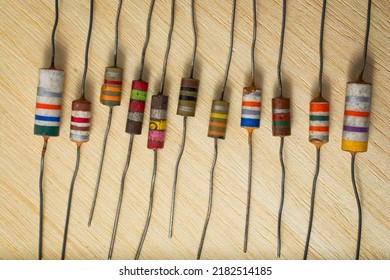 Colorful Vintage Electronic Resistors Lined Up On A Wooden Workbench. Top Down View.