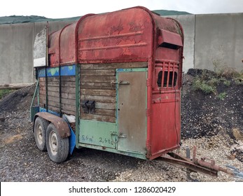 Colorful vintage horse trailer made of wood and iron, used by farmers for horse transportation, on an abandoned site