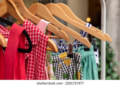 Colorful Vintage Thrift Store Clothes With Different Patterns, Colors And Textures Hanging On A Rack. Recycle, Reuse, Sustainable Circular Economy Principle