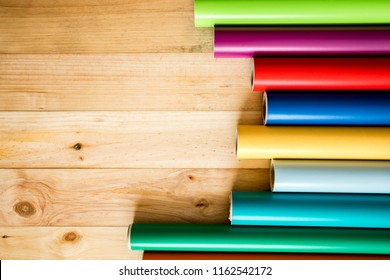 Colorful vinyl rolls on wooden background