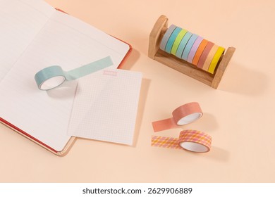Colorful washi tapes and stationery items arranged on a light background during a creative workspace session
