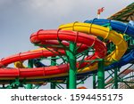 Colorful water Park twisted water slide amusement resort for luxury children and family vacations on a warm sunny tropical day.