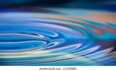 Colorful Water Ripples In A Smooth Pool Of Water