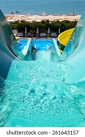 Colorful Waterpark Tubes And A Swimming Pool. Outdoor Shot