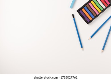 Colorful wax crayons and pencils isolated on white background. Copy space. Top view. - Powered by Shutterstock