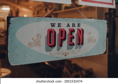 Colorful We Are Open Sign On A Glass Front Door Of A Restaurant.