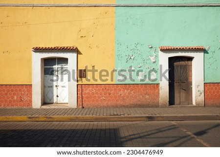 Colorful weathered facades on Morelos Avenue downtown Cholula magical town, Puebla, Mexico. Typical Mexican village.