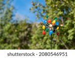 Colorful wind lawn ornament with soft bokeh background.