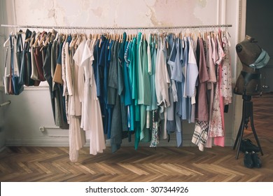 Colorful Women's Dresses On Hangers In A Retail Shop. Fashion And Shopping Concept. Toned Picture