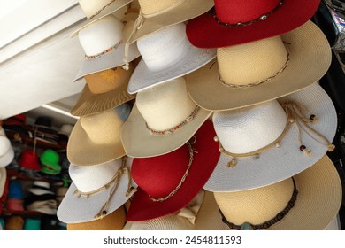 Colorful women's fedora hat models for sale, retail store outdoor, beige, white and red color - Powered by Shutterstock