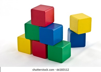 Colorful Wood Building Blocks Stacked As Pyramid. Isolated On White