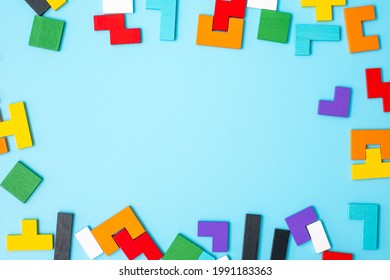 colorful wood puzzle pieces on blue background, geometric shape block with copy space. Concepts of logical thinking, Conundrum, solutions, rational, strategy, world logic day and Education - Powered by Shutterstock