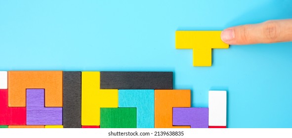 colorful wood puzzle pieces on blue background, geometric shape block. Concepts of logical thinking, Conundrum, solutions, rational, strategy, world logic day and Education - Powered by Shutterstock