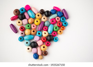 Colorful wooden beads in a shape of a heart - Powered by Shutterstock