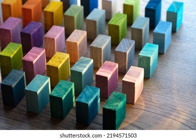 Colorful wooden blocks placed in intervals on a rustic wooden table with incoming light. Diversity, variation, assortment concept. Shallow depth of field. - Shutterstock ID 2194571503