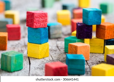 Colorful wooden building blocks. Selective focus - Shutterstock ID 306641441