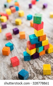 Colorful wooden building blocks. Selective focus - Shutterstock ID 328778861