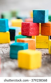 Colorful wooden building blocks. Selective focus - Shutterstock ID 379238368