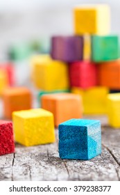 Colorful wooden building blocks. Selective focus - Shutterstock ID 379238377