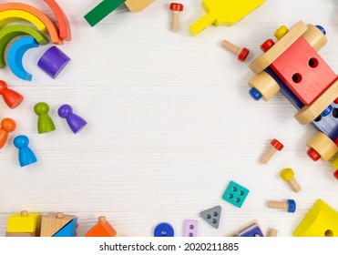 A Colorful Wooden Building Kit For Children On Wood. Set Of Tools On White Wooden Table. Games And Tools For Kids In Kindergarten, Preschool Or Daycare. Natural, Eco-friendly Toys. Back To School 