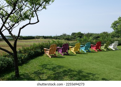 Colorful wooden chairs at the farm