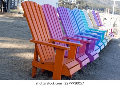 Colorful wooden chairs on sand beach. - Shutterstock ID 2279930057