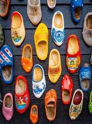 Colorful Wooden Clogs On Dark Wooden Panels