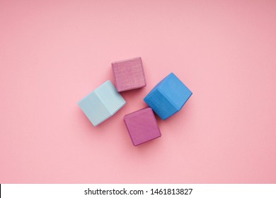Colorful wooden cubes on pink background.Creativity toys. Children's building blocks