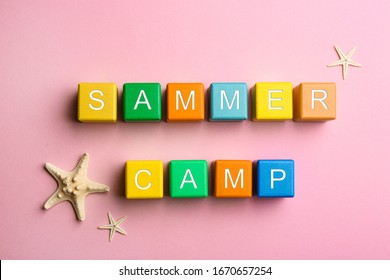 Colorful Wooden Cubes With Phrase SUMMER CAMP On Pink Background, Flat Lay