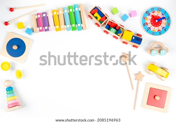 Colorful wooden\
educational and musical toys for baby kids on white background. Top\
view, flat lay frame