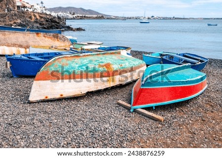 Colorful wooden fishing boats on the beach at the ocean. Fishing village boats