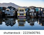 Colorful wooden house boats reflected into the still water of  Richardson Bay in Sausalito, California. 