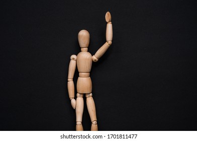 A colorful wooden mannequin raises his hand against the background of other mannequins. The character reports to the project, other people do not want to take part in the project. Lifestyle. - Powered by Shutterstock