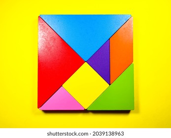 Colorful Wooden Tangram On A Yellow Background.