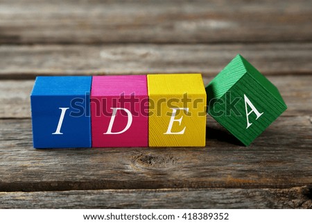 Colorful wooden toy cubes on a grey wooden background