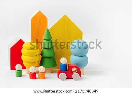 Colorful  wooden toys. Houses, trees, toy cars and little men in the colors of the rainbow. Games for learning and development of the child. Wooden play set. 