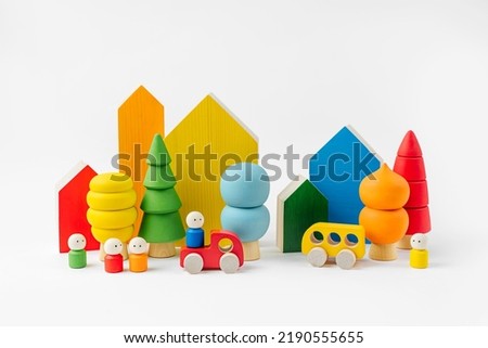 Colorful  wooden toys. Houses, trees, toy cars and little men in the colors of the rainbow. Cute kids toys to play and for decorating children's room. Wooden play set. 