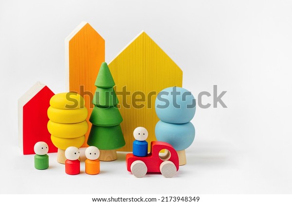 Colorful  wooden toys. Houses, trees,\
toy cars and little men in the colors of the rainbow. Games for\
learning and development of the child. Wooden play set.\
