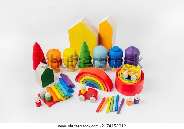Colorful  wooden toys.\
Houses, trees, toy cars and little men in the colors of the\
rainbow. Cute kids toys to play and for decorating children\'s room.\
Wooden play set. 