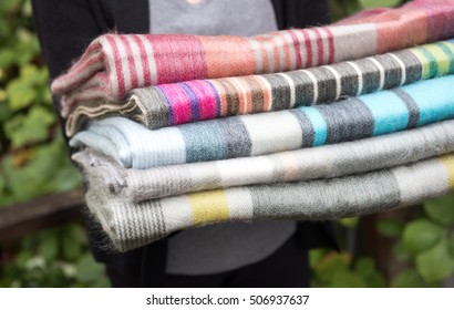 Colorful Wool And Alpaca Blankets Stacked In Pile