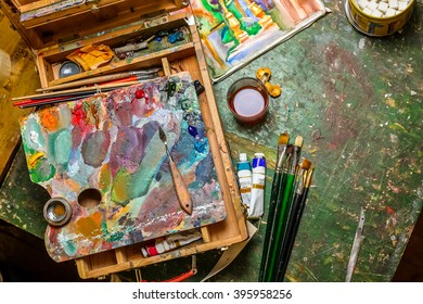 Colorful Workplace Of The Artist With Brushes And Oil Paints