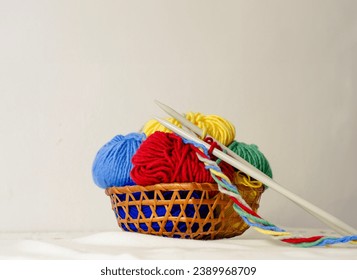 Colorful yarn balls in wicker bowl, knitting, crochet concept - Powered by Shutterstock