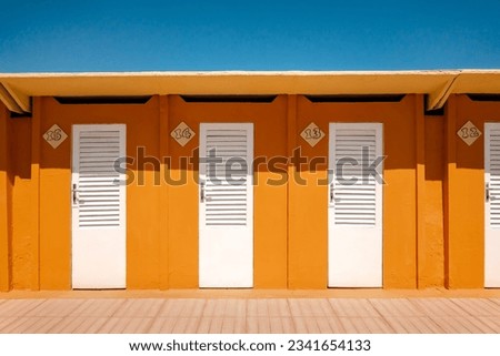 Colorful yellow beach huts in Rimini, Adriatic sea, Italy.