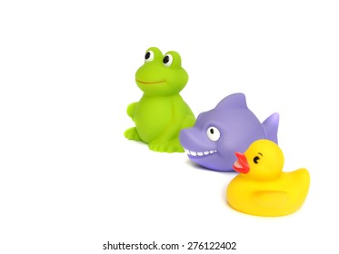 Colorful Yellow Rubber Duck And Other Bath Toys Looking Left Isolated On White