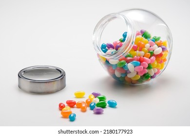 Colorfull jelly beans in round glass jar, isolated on white - Powered by Shutterstock