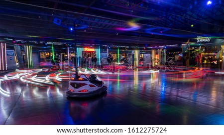 Colorfull long exposure of bumper cars in Vienna during night time with one unmanned cart