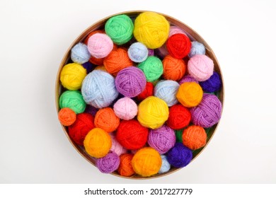 A lot colorful woolen balls knitted yarn in round cardboard box white background The concept handmade work  needlework   the sale thread Top view Flatlаy Rainbow layout Copyspace 